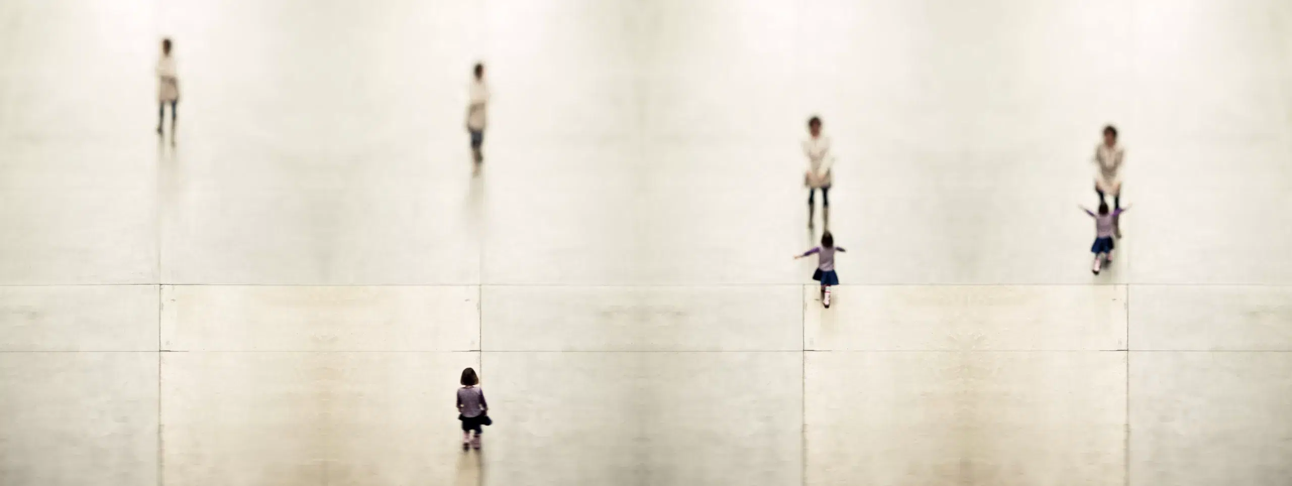 Experimental fine art photography featuring a digital composite of blurred figures in motion within the Tate Modern’s turbine hall, highlighting body language and spatial interaction.