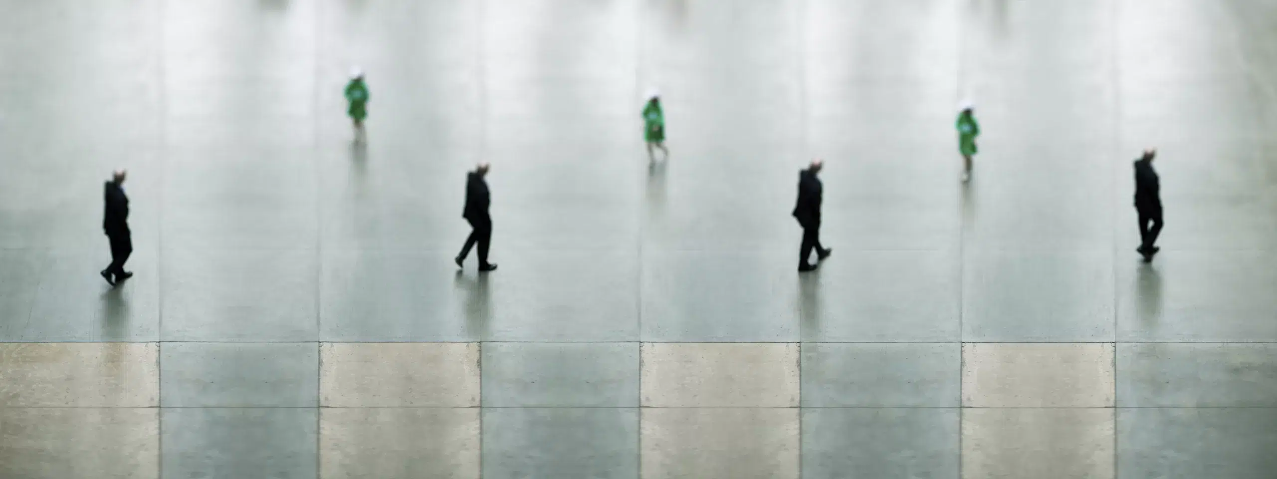 Experimental fine art photography featuring a digital composite of blurred figures in motion within the Tate Modern’s turbine hall, highlighting body language and spatial interaction.